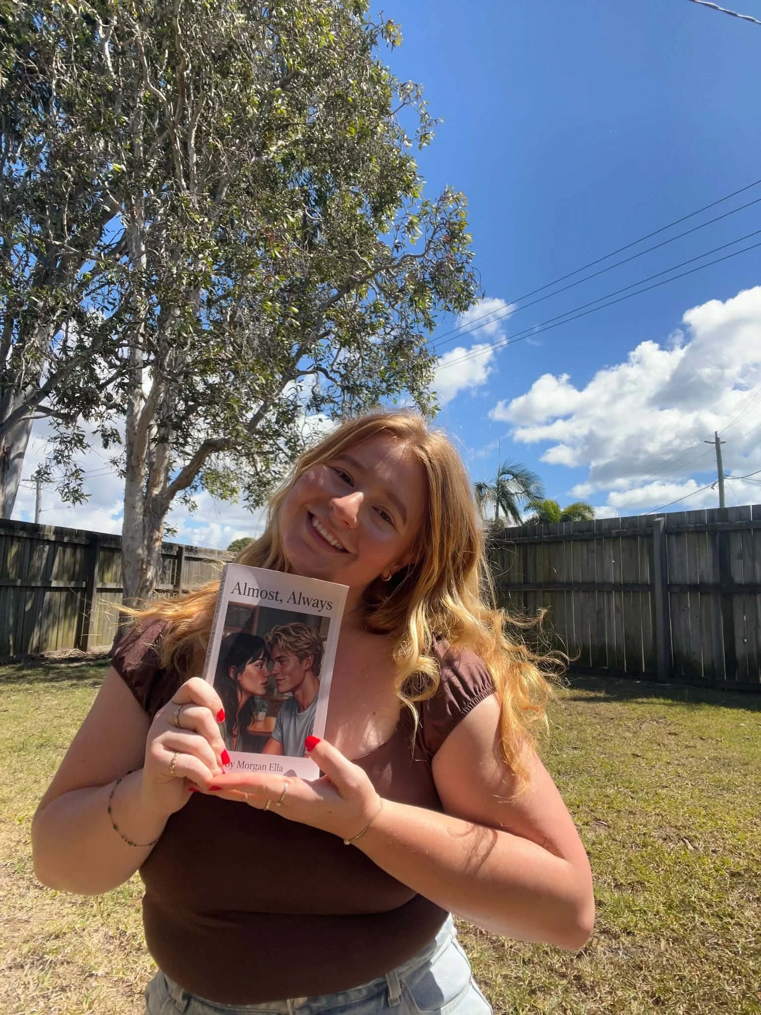 Morgan holding her book Almost, Always